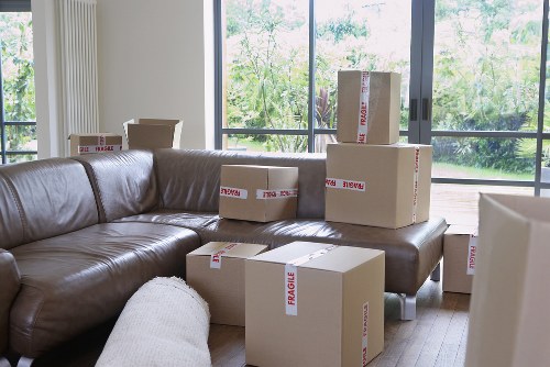 Packed boxes and furniture being loaded into a removal van